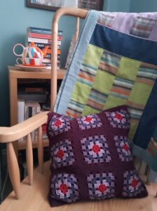 Purple granny square cushion