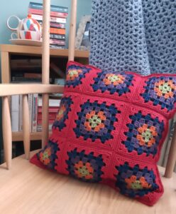 Red granny square cushion